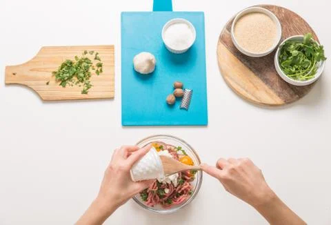 Good-looking female hands while preparing delicious traditional italian meatb Stock Photos
