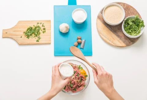 Good-looking female hands while preparing delicious traditional italian meatb Stock Photos