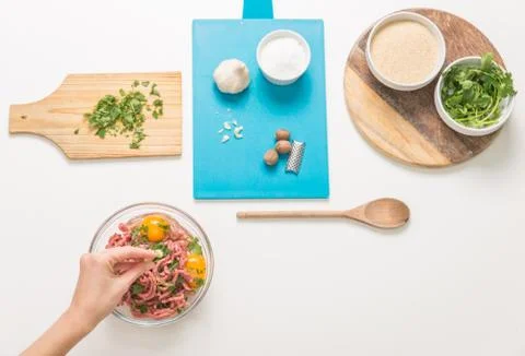 Good-looking female hands while preparing delicious traditional italian meatb Stock Photos