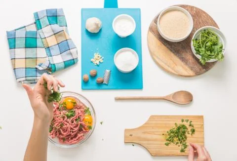 Good-looking female hands while preparing delicious traditional italian meatb Stock Photos