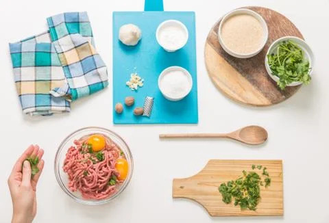 Good-looking female hands while preparing delicious traditional italian meatb Stock Photos