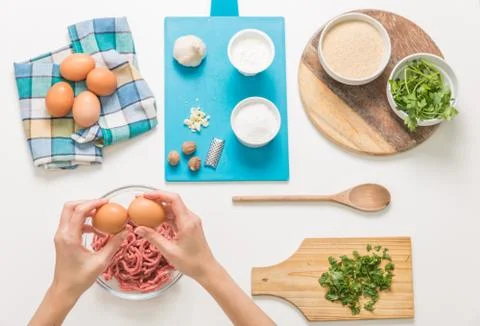 Good-looking female hands while preparing delicious traditional italian meatb Stock Photos