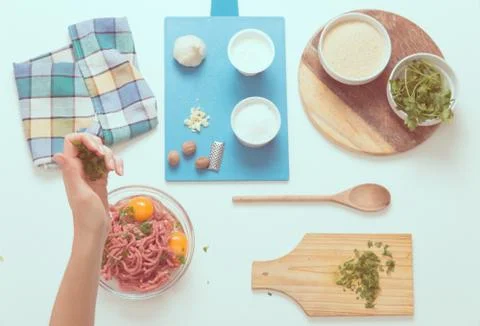 Good-looking female hands while preparing delicious traditional italian meatb Stock Photos