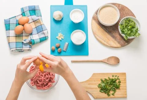 Good-looking female hands while preparing delicious traditional italian meatb Stock Photos