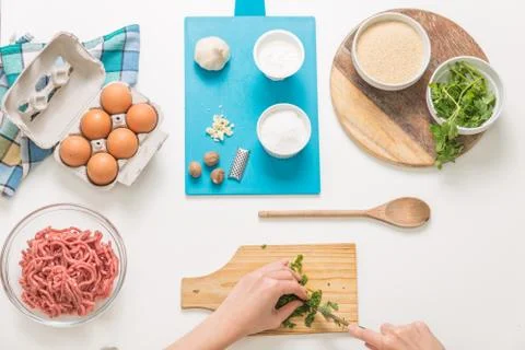 Good-looking female hands while preparing delicious traditional italian meatb Stock Photos