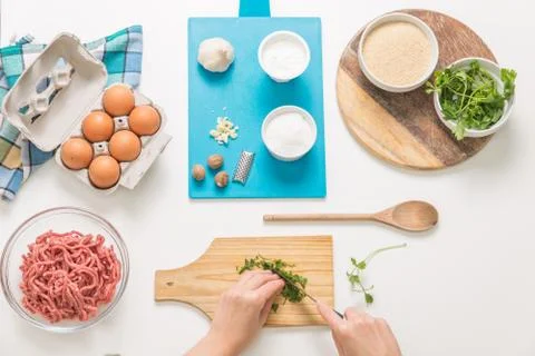 Good-looking female hands while preparing delicious traditional italian meatb Stock Photos