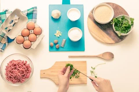 Good-looking female hands while preparing delicious traditional italian meatb Stock Photos