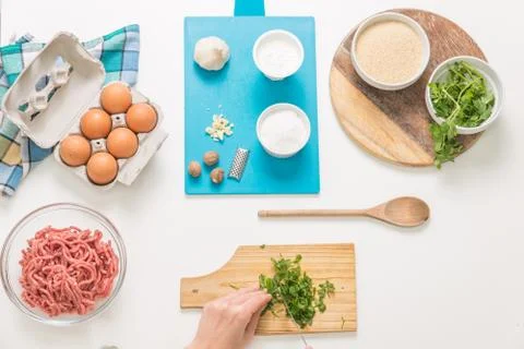 Good-looking female hands while preparing delicious traditional italian meatb Stock Photos