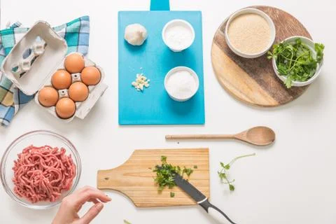 Good-looking female hands while preparing delicious traditional italian meatb Stock Photos