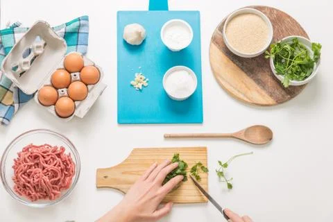 Good-looking female hands while preparing delicious traditional italian meatb Stock Photos