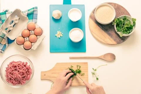 Good-looking female hands while preparing delicious traditional italian meatb Stock Photos