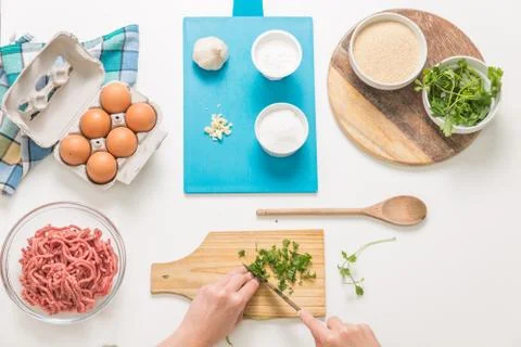Good-looking female hands while preparing delicious traditional italian meatb Stock Photos