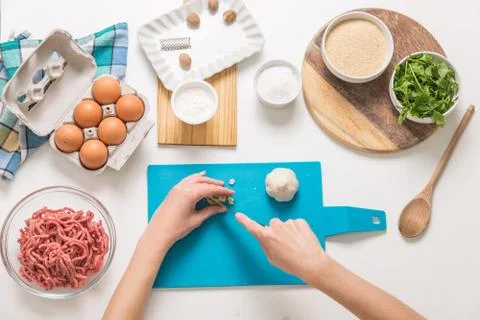 Good-looking female hands while preparing delicious traditional italian meatb Stock Photos
