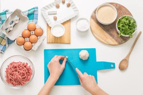Good-looking female hands while preparing delicious traditional italian meatb Stock Photos