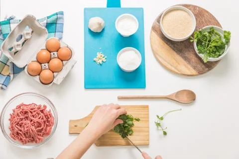 Good-looking female hands while preparing delicious traditional italian meatb Stock Photos