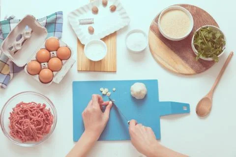 Good-looking female hands while preparing delicious traditional italian meatb Stock Photos