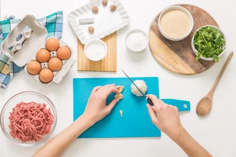 Good-looking female hands while preparing delicious traditional italian meatb Stock Photos