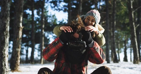 Good looking guy and a pretty lady have a funny time together on a hard winter Video stock 111968954