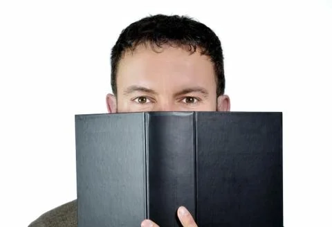 Good looking guy behind book Stock Photos