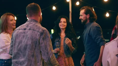 Good looking guy came to the party he say he to everyone and hugging his friends Stock Footage 164323449