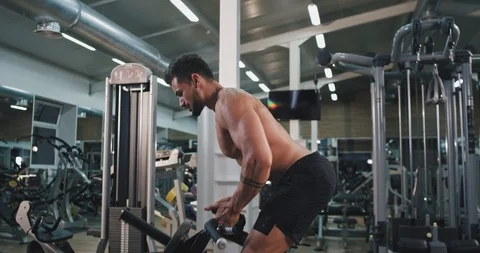 Good looking guy with a perfect body lifting up the weights at gym class Stock-Footage 116037004