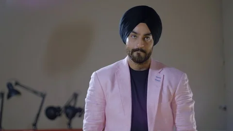 Good looking handsome, smart and sharp, turbaned man listens to someone off scre Stock Footage 102419453