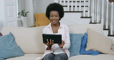 Good-looking happy smiling young modern black woman with african hairstyle Stock Footage 144265161