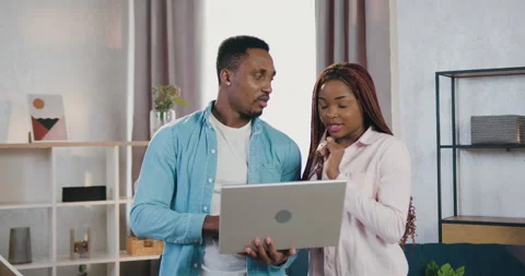 Good-looking happy smiling young african american couple standing in front of Stock Footage 150701422
