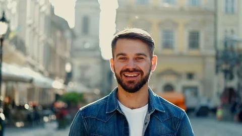 Good-looking happy young man in stylish clothes in the urban street looking on t Stock Footage 112352039