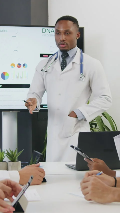 Good-looking high-skilled successful mixed race doctors sitting at the table in  Stock Footage 331370140