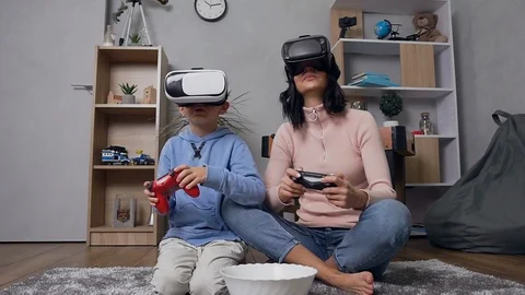 Good-looking high-spirited modern mother and son wearing special virtual 3d Stock Footage 122846195