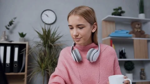 Good-looking high-spirited young blond woman in pink sweater which looking at Stock Footage 123070878