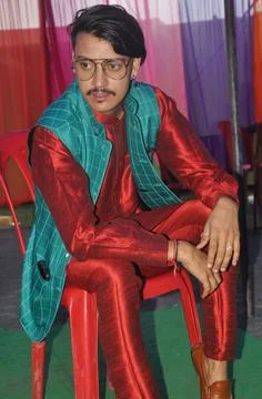 A good looking Indian young guy posing with sitting on chair with wearing kurta Foto stock