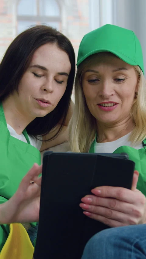 Good-looking joyful professional young women-workers of cleaning company sitting Stock Footage 327873904