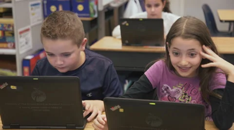 Good looking kids on the computer smlling Video stock 62655697