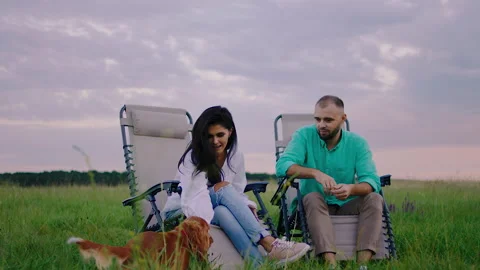 Good looking lady and her partner at nature have a picnic they sitting on the Video stock 166846279