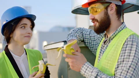 Good looking lady architect and engineer man at the break time while eating some Stock Footage 143159469