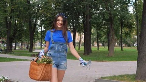 Good-looking long haired brunette woman is walking in the park Stock Footage 103024337