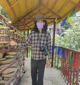 A good looking long haired young guy wearing face mask and sun hat Stock Photos