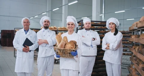 Good looking main team in a bakery industry bakers engineer looking straight to Stock Footage 112345132