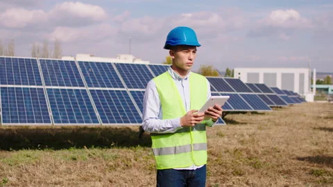 Good looking man Asian looking ecological engineer uses digital tablet to Stock Footage 163968015