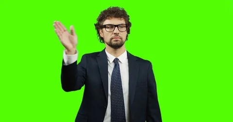 Good looking man in the glasses, suit and tie standing on the chroma key Stock-Footage 90725331