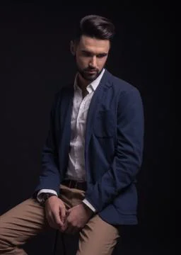 Good looking man, looking down, wearing suit. Stock Photos