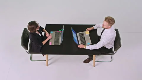 Good looking man office worker and the office manager woman sitting at the same Video stock 132008542