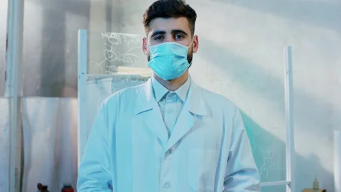 Good looking man pharmacist in the pharmaceutical lab posing in front of the Stock Footage 153089692