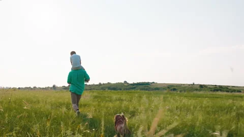 Good looking man running fast together with his small son on the back and cute Stock Footage 170006648