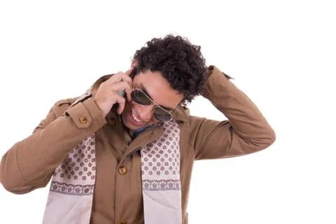 Good looking man with sunglasses wearing jacket and scarf talking on mobile p Stock Photos