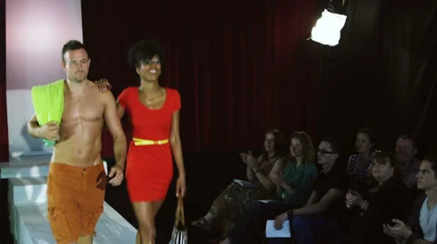 Good looking models walk down on the catwalk in beach wear and audience applaud Vídeo Stock 32740739