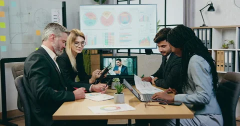 Good-looking motivated smart experienced mixed race businesspeople brainstorming Stock Footage 161022900