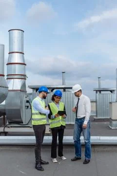 Good looking multiethnic group of workers in a modern building construction site Stock Photos